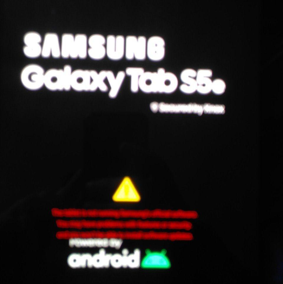 Black screen, white Samsung Logo, below white Galaxy Tab S5e. Yellow triangle with ! in it and red writing that inofficial software is being executed
